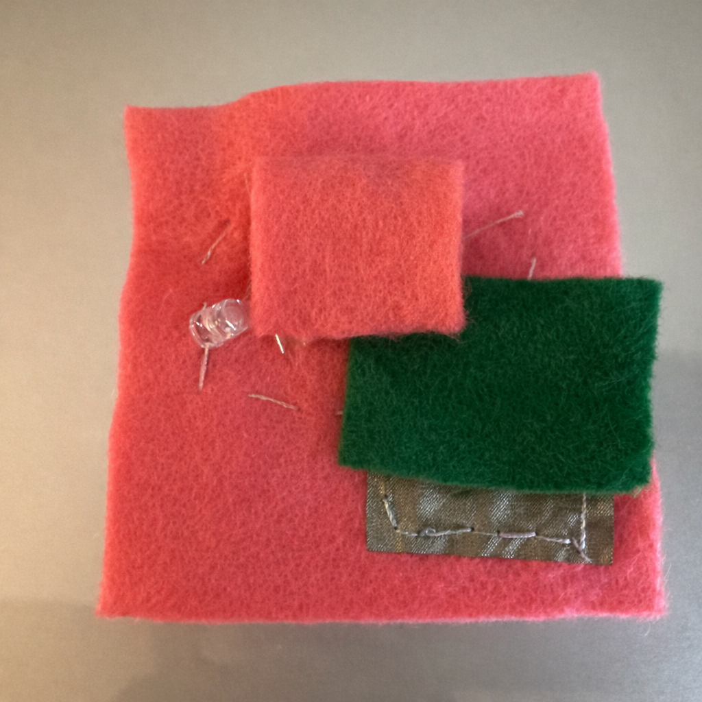 I continued using felt and conductive thread, and this time I added conductive fabric in the bottom right corner.