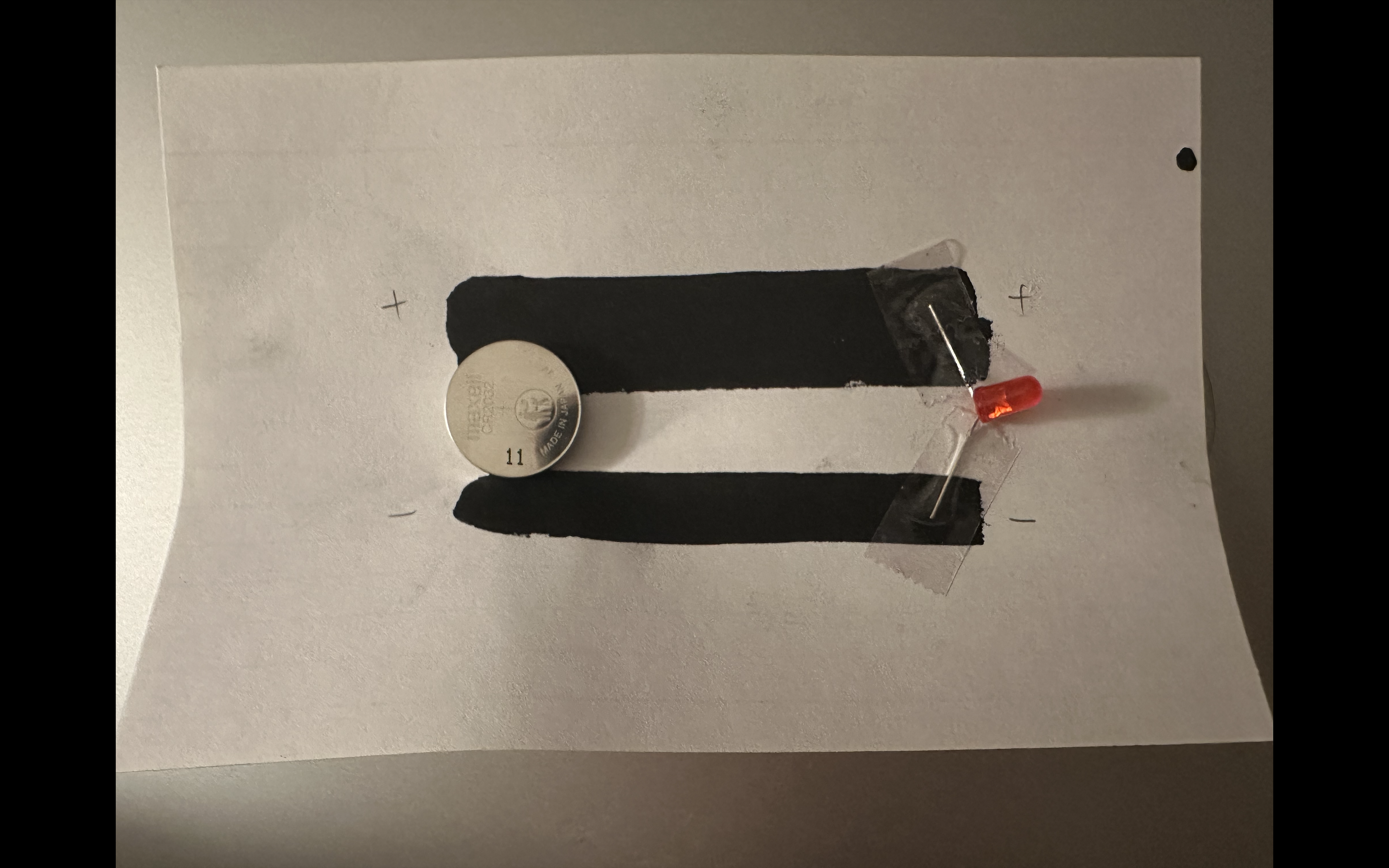 I taped the LED onto the conductive paint and placed the battery on the left side.